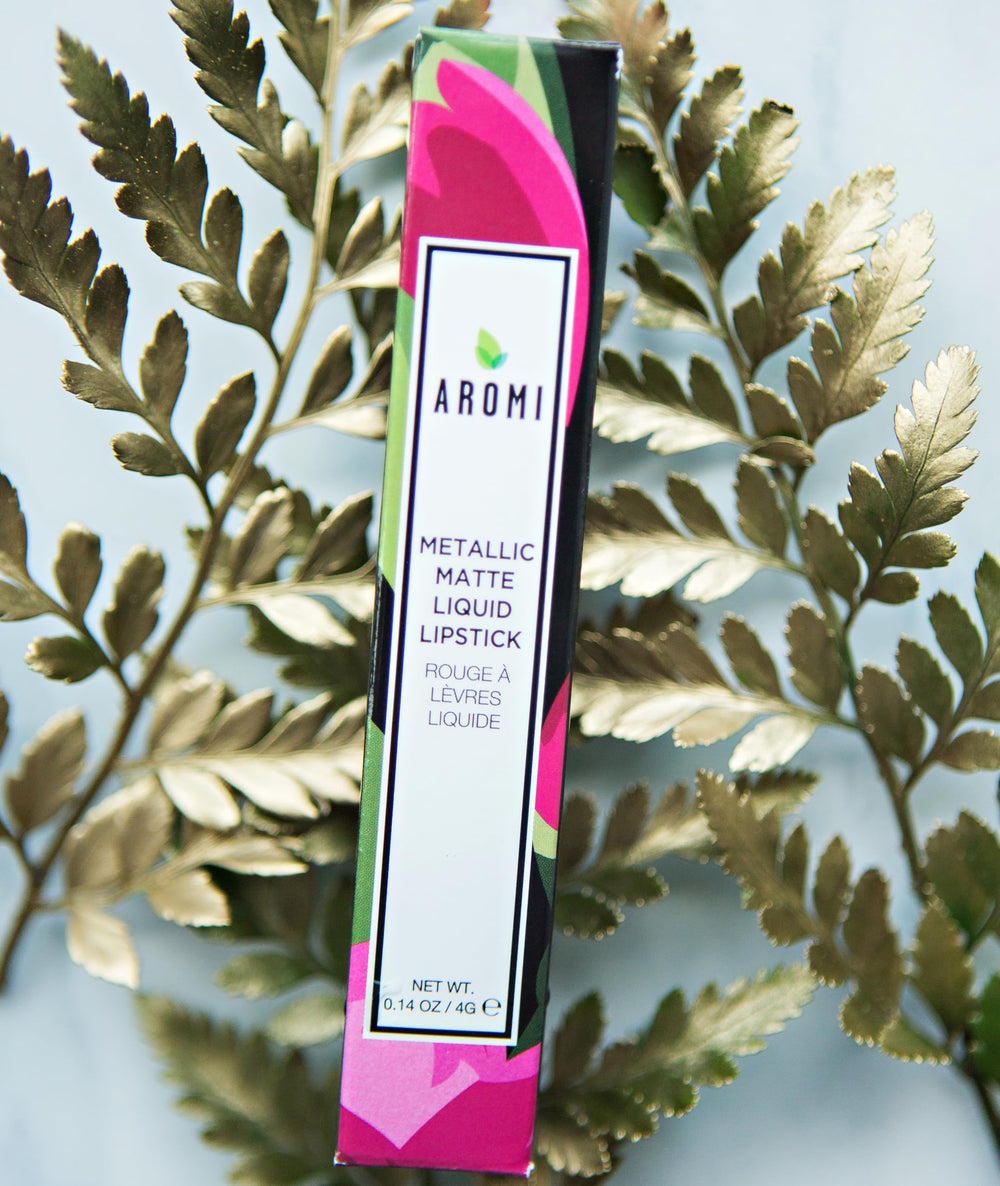 Aromi Berry Fuchsia lipstick on lips with metallic finish