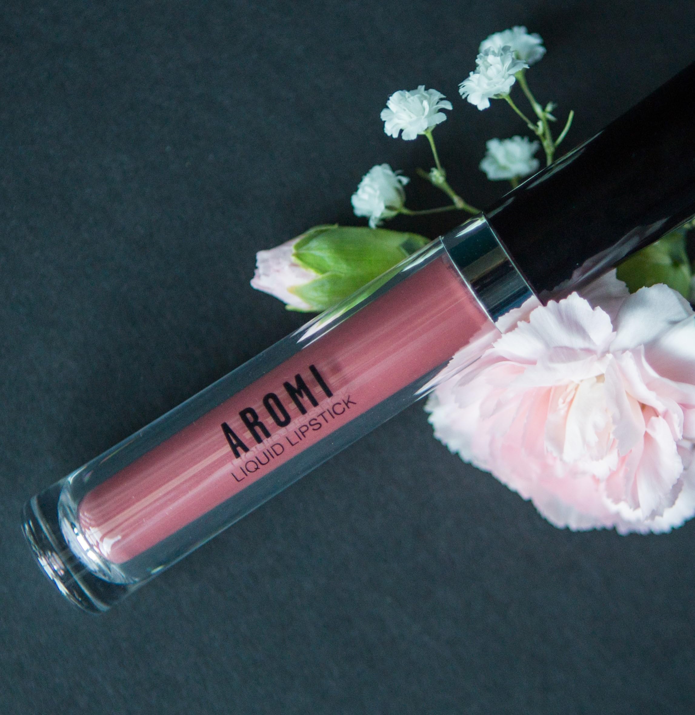 Aromi Chestnut Rose lip color on model lips in warm lighting.