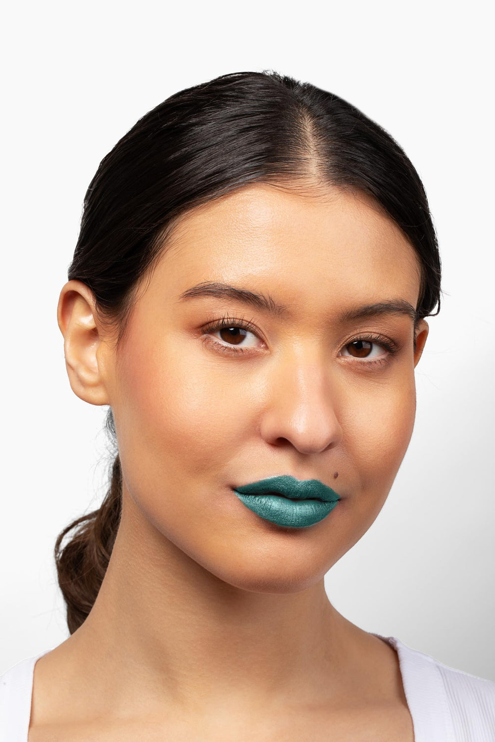 Aromi Green Metallic Lipstick swirl shows turquoise-teal shimmer for a bold look.