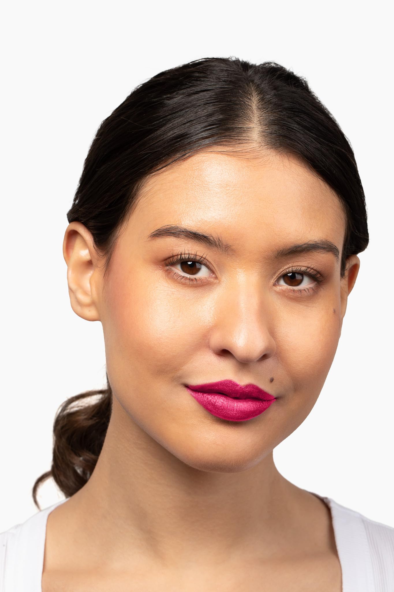 Aromi lipstick being applied for a glossy, wet-look base that dries to metallic.