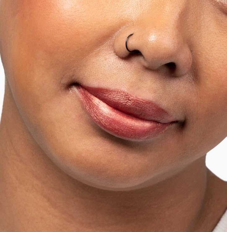 Close-up of Aromi metallic lipstick application for a smooth finish