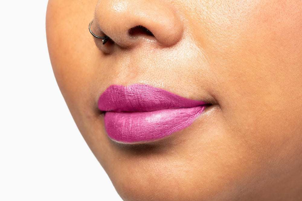 Skin swatch reveals long-lasting color of Aromi Moody Magenta.