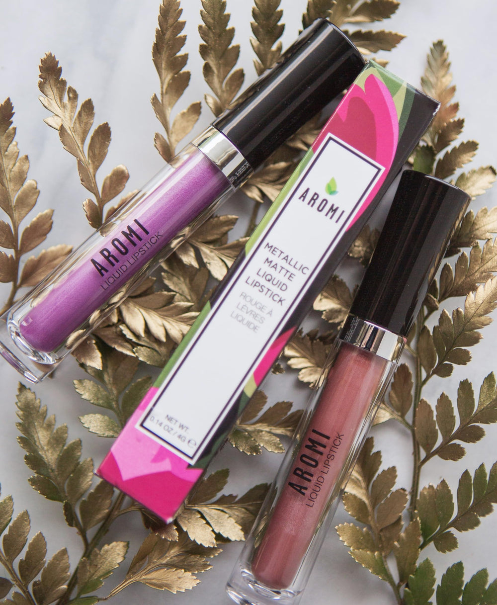 Aromi Tan Metallic Lipstick Sepia Bronze swatch on skin reveals peachy undertones.