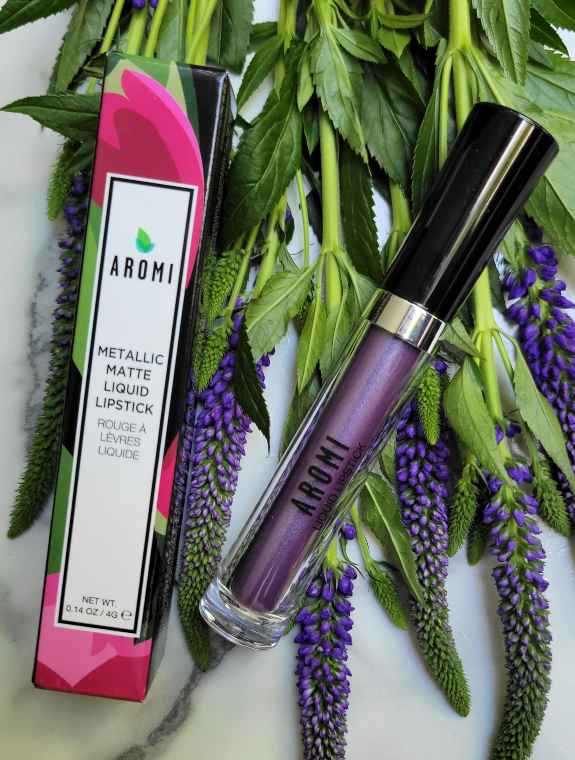 Aromi Violet Plum swatch on skin demonstrates buildable color and shimmer.