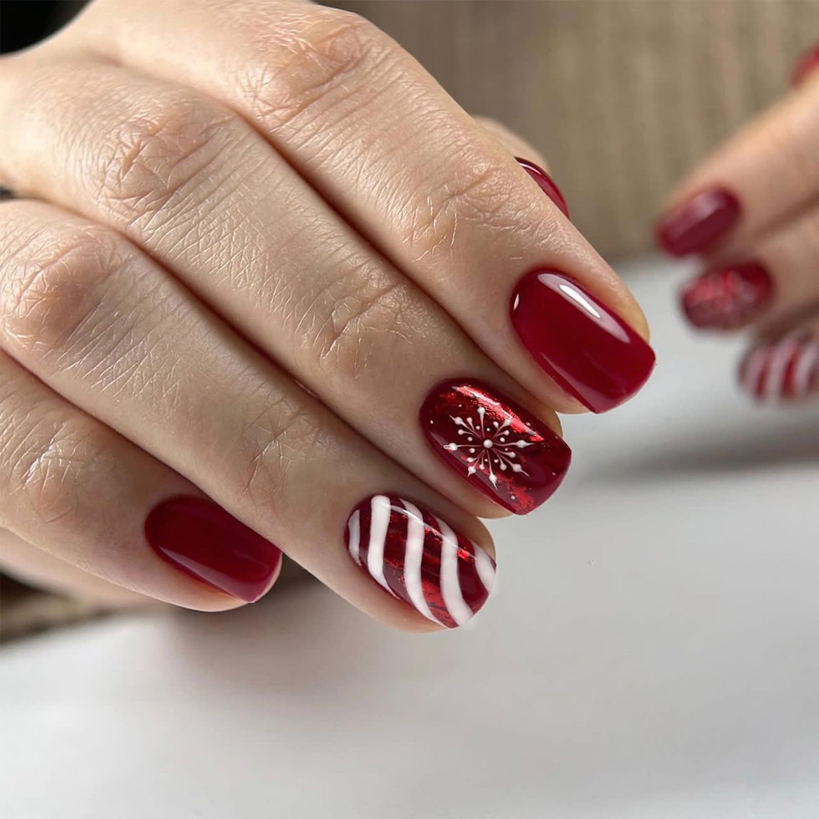 AROVFAM Christmas snowflake nails with glossy red curve line for festive style.