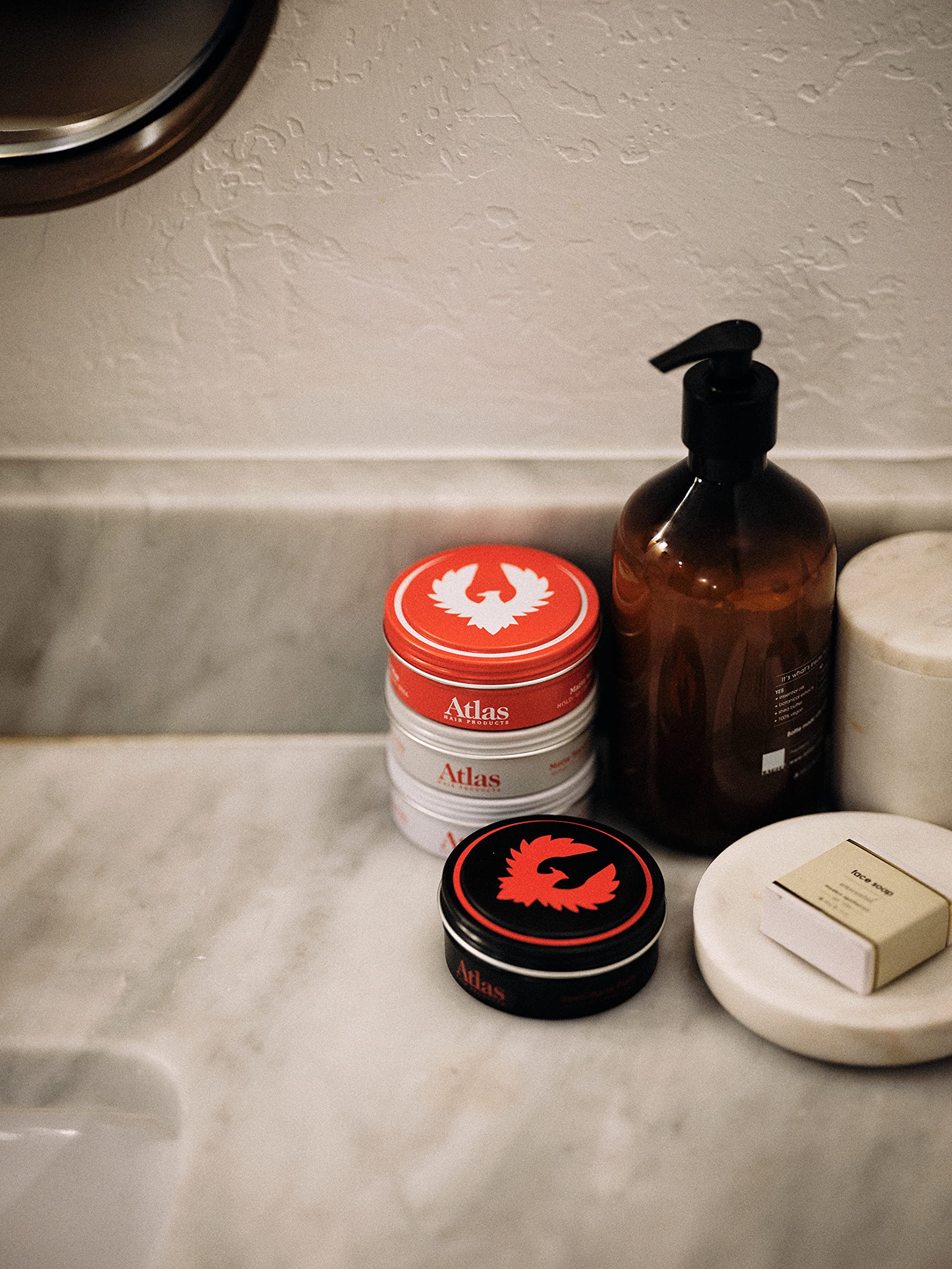 Atlas Pomade travel-sized tin demonstrates TSA-approved portability.