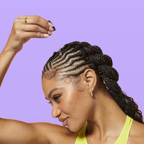 Hands applying Batana Oil for lightweight strength and softness