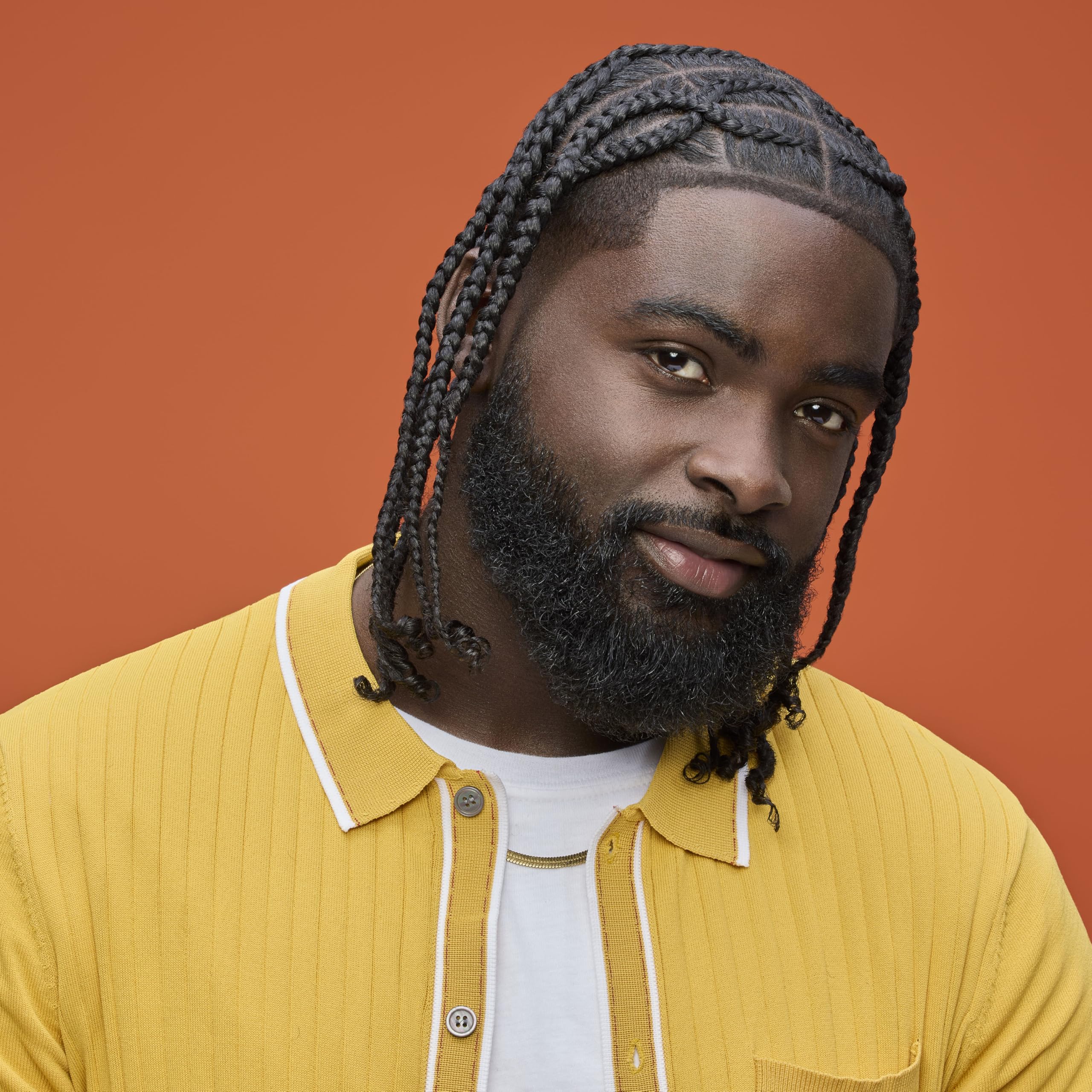 Product in a setting with braids or locs to show usage.
