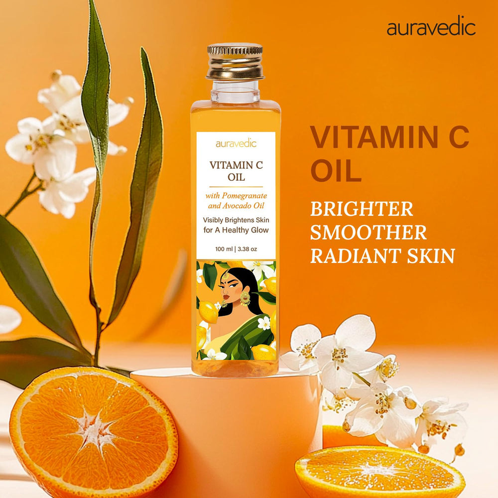 Auravedic Vitamin C Face Oil dropper releasing oil for facial application.