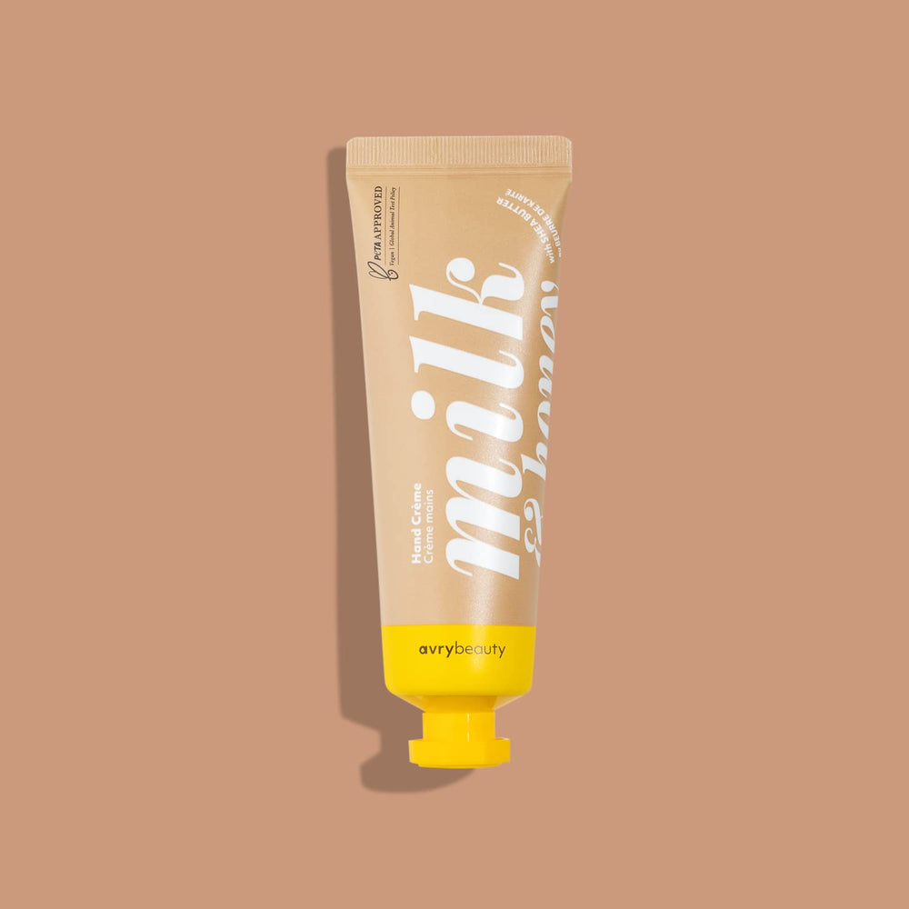 Close-up of AVRYBEAUTY Milk and Honey lotion, a portable 1.5oz tube.