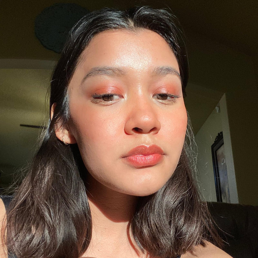 Axiology Balmie applied to lips for long-lasting color.