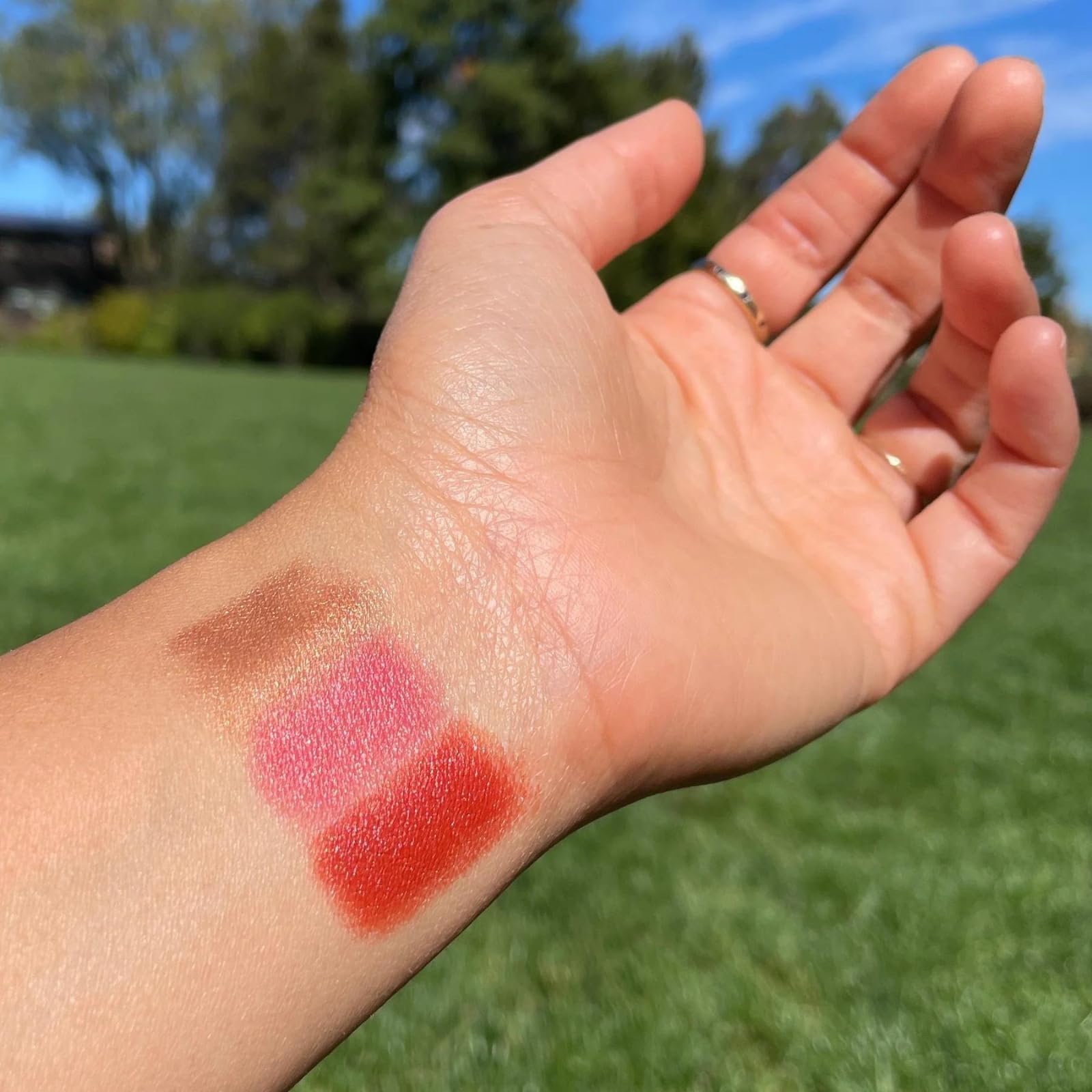 Axiology Golden Hour shade applied to multiple skin tones.