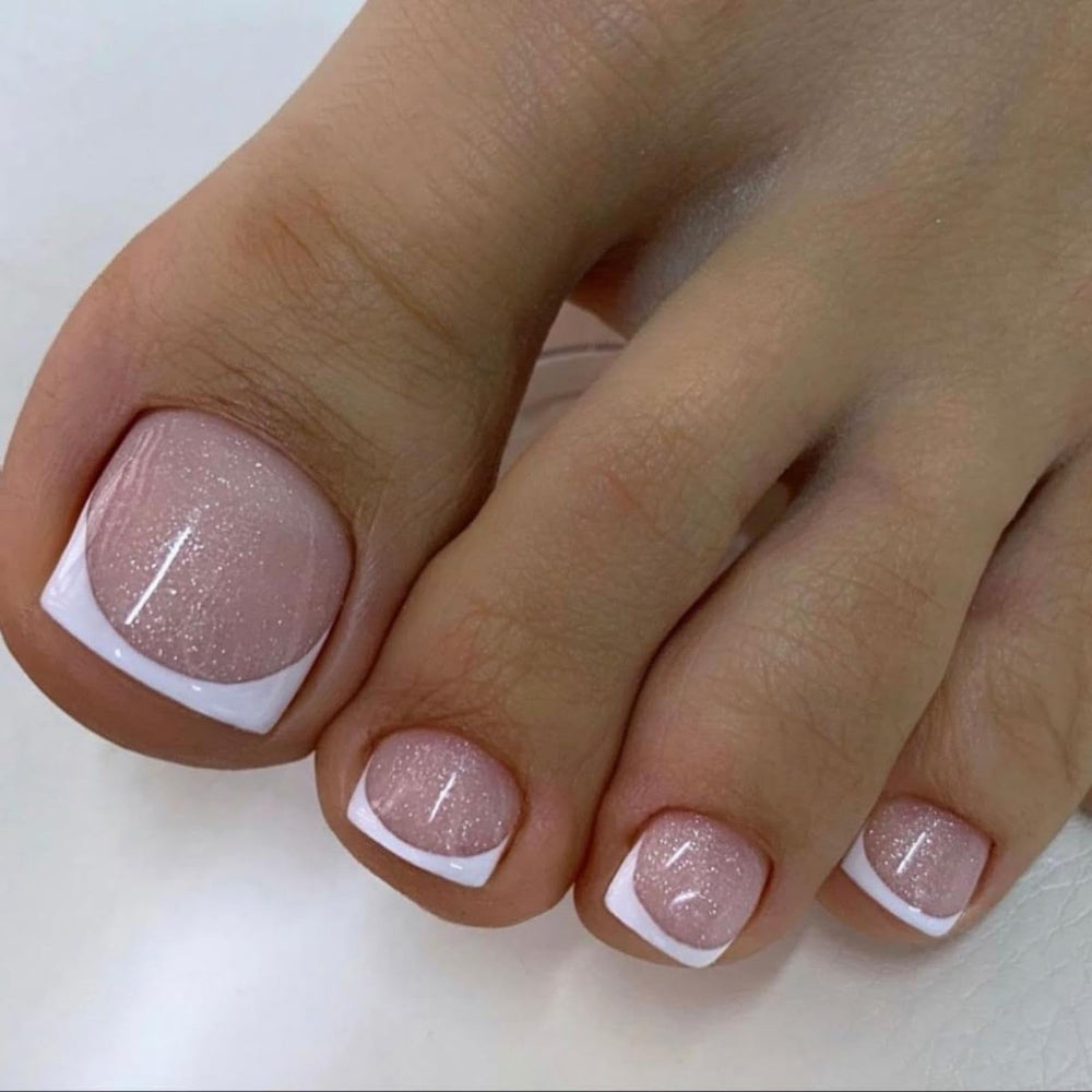 AZPEPSI white French tip toenails with short square shape for natural nude glitter look.