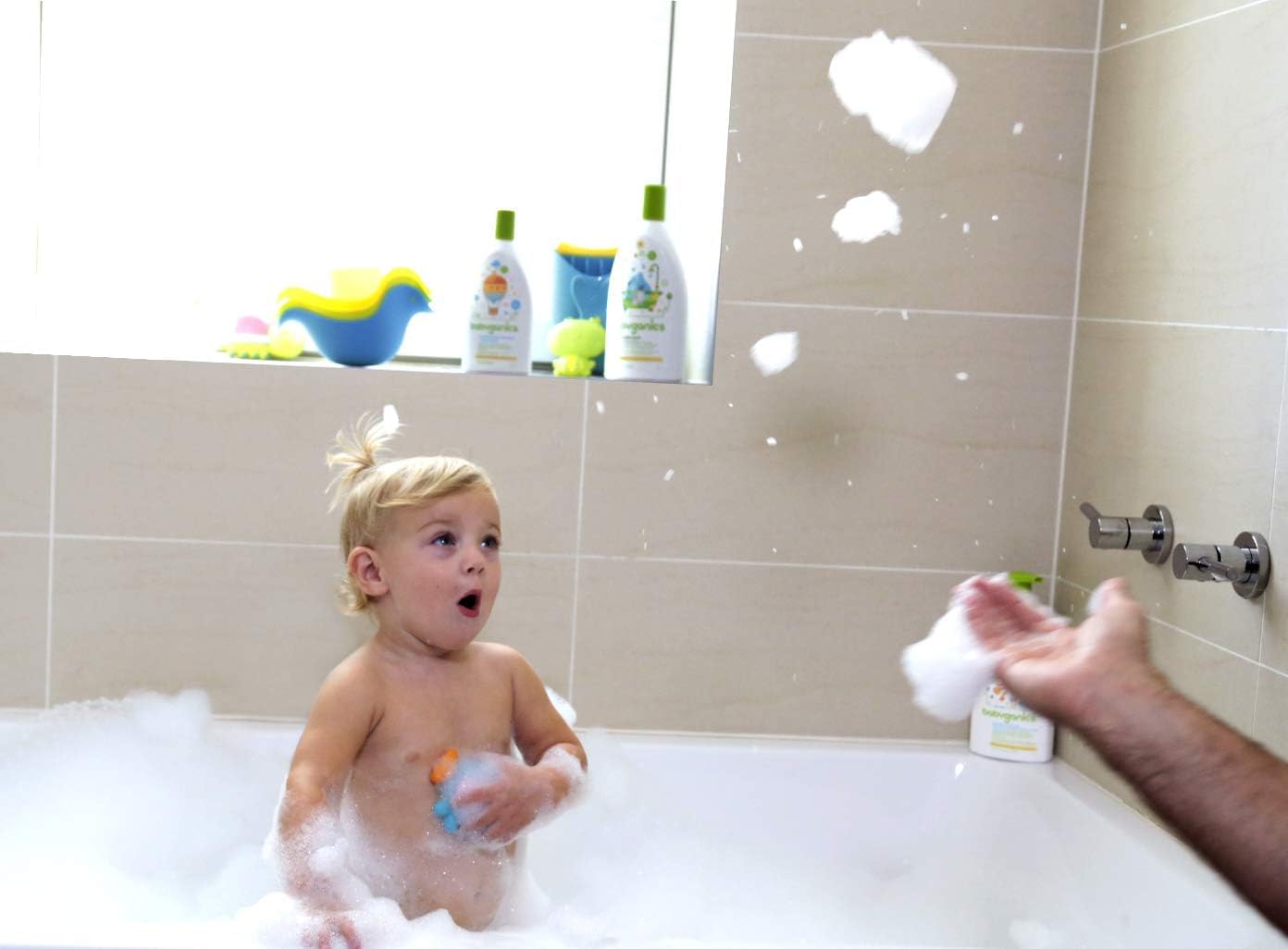 BabyGanics bottle shown in use for gentle family bath.