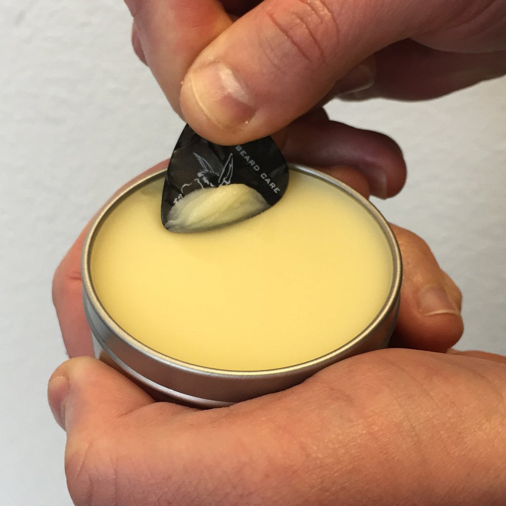 Badass Beard Care applying balm to beard offers soothing hydration.