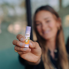 Badger Lavender Orange Lip Balm being applied for smooth lips.