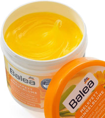 Applying Balea Milk Fat Marigold cream to soothe dry skin.