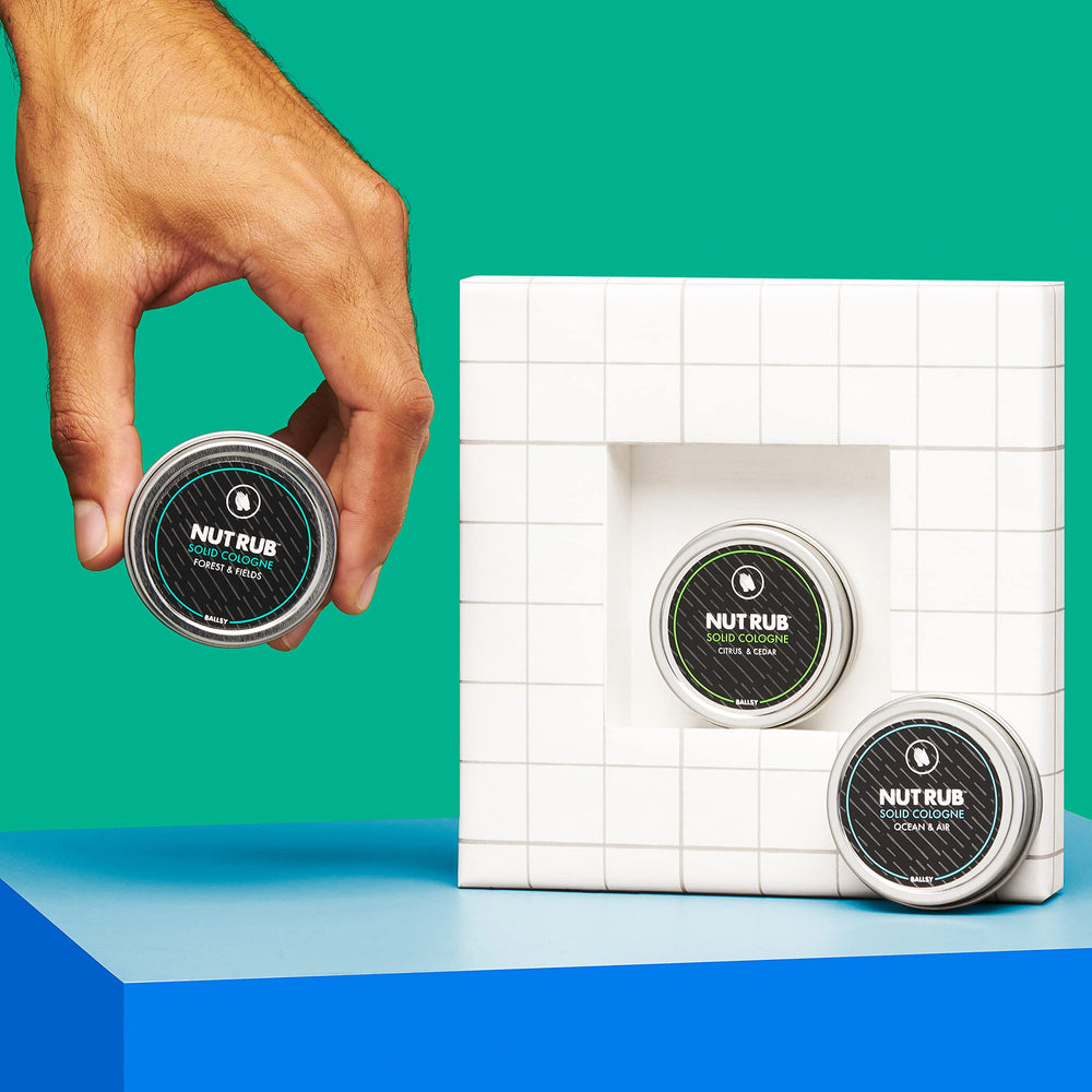 Ballsy travel size 0.85 oz container shows portable scent application.