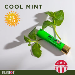 Balmshot lip balm in outdoor adventure setting for camping or hiking.