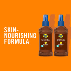 Banana Boat Deep Tanning Oil SPF 4 spray in action for easy dispensing.