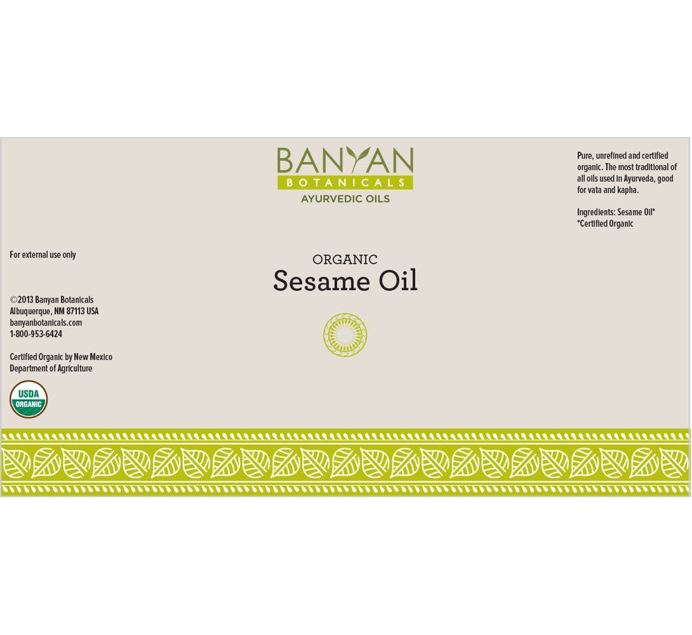 Sesame oil golden hue labeled Banyan Botanicals for hair and skin use.