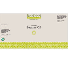 Sesame oil golden hue labeled Banyan Botanicals for hair and skin use.