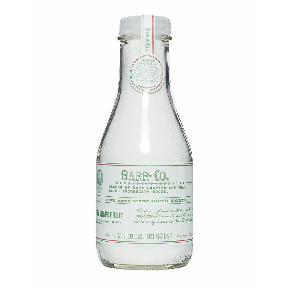 Barr-Co fir grapefruit bath salts jar shown in glass for relaxing soaks.