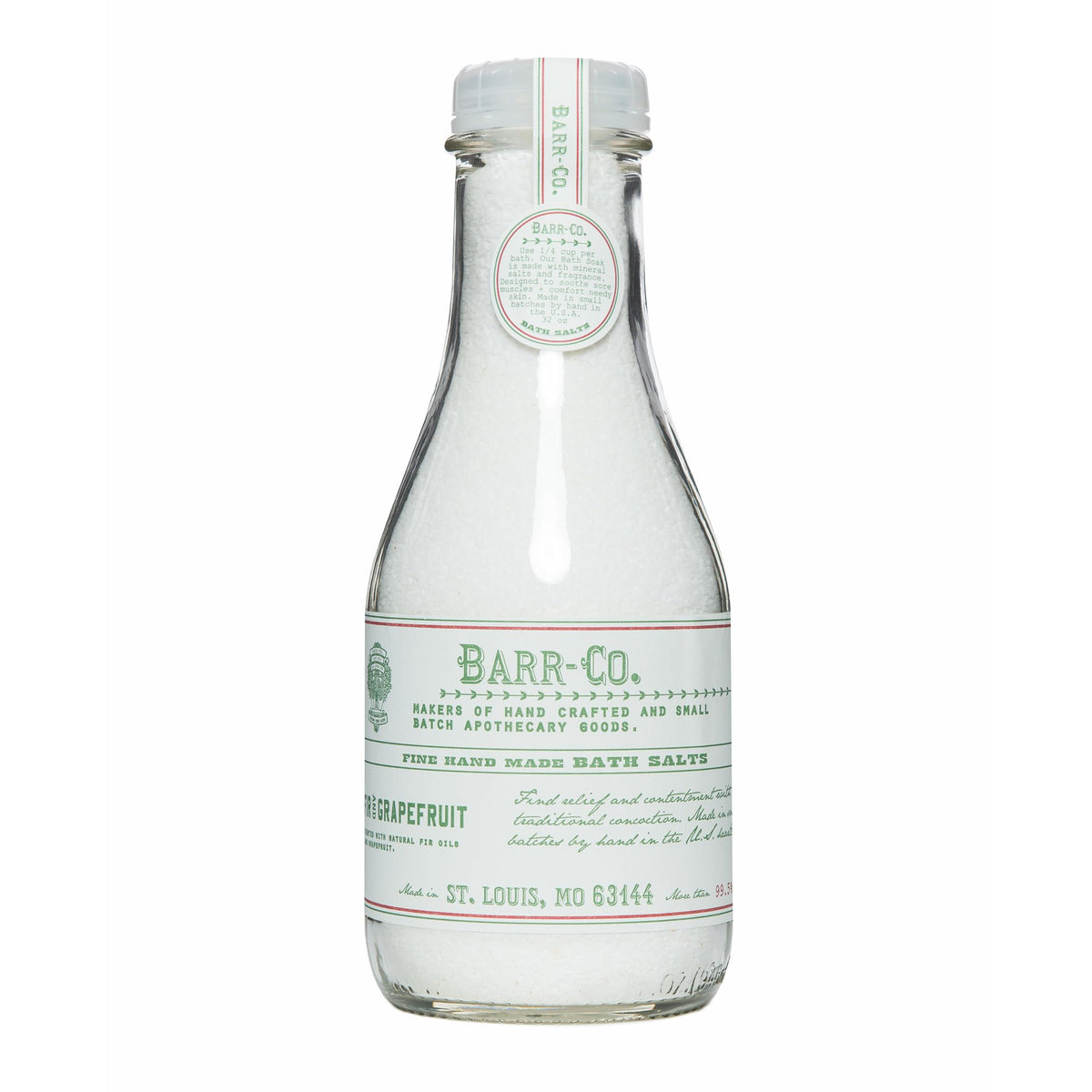 Barr-Co fir grapefruit bath salts jar shown in glass for relaxing soaks.
