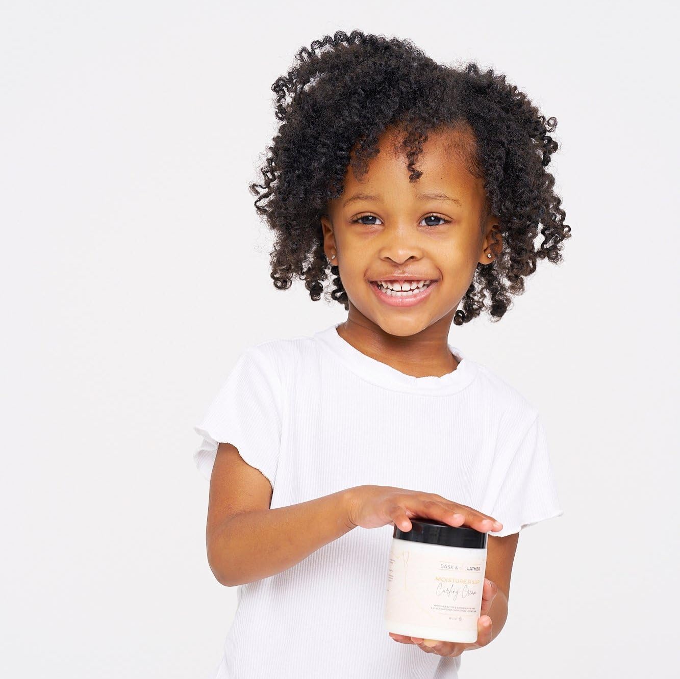 BASK & LATHER slippery elm eases detangling and controls frizz on curls