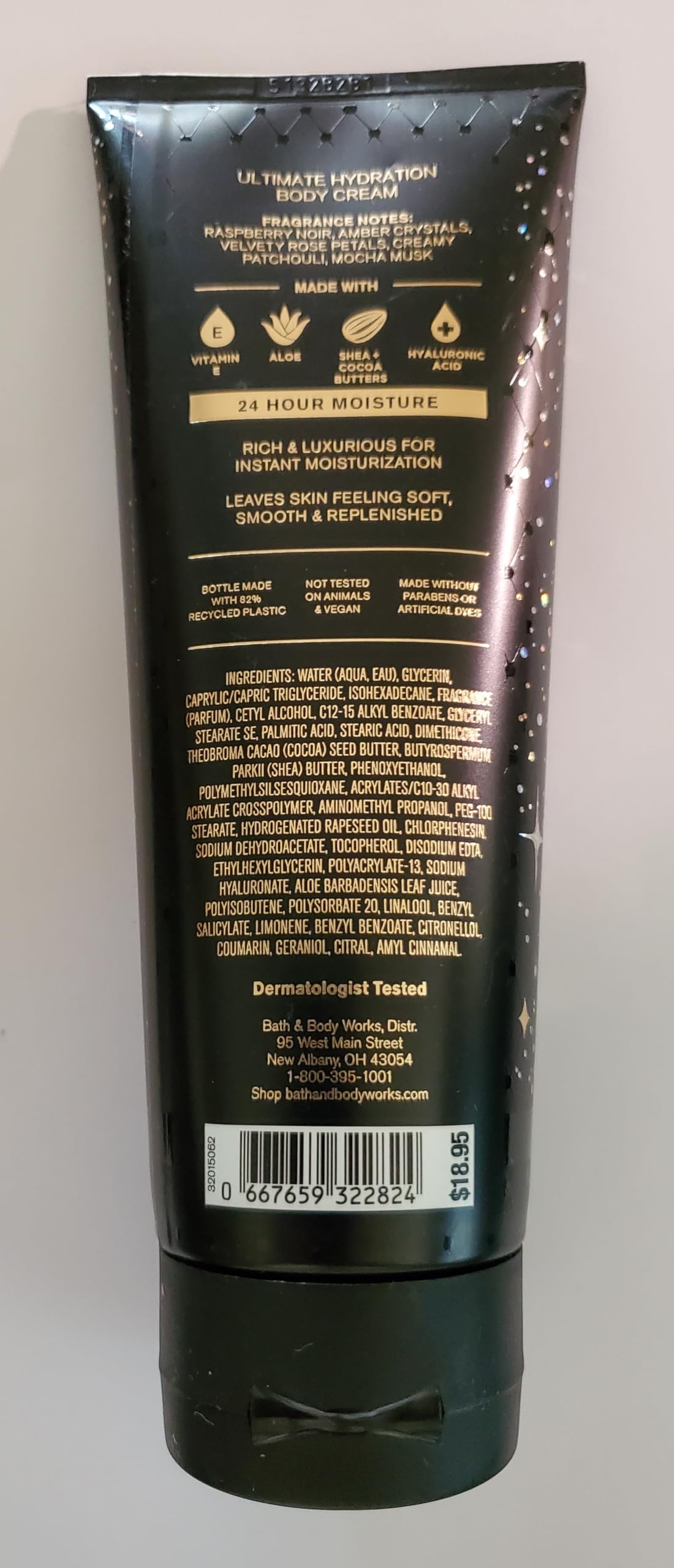 Fragrance note visuals hinting at raspberry noir and amber warmth.
