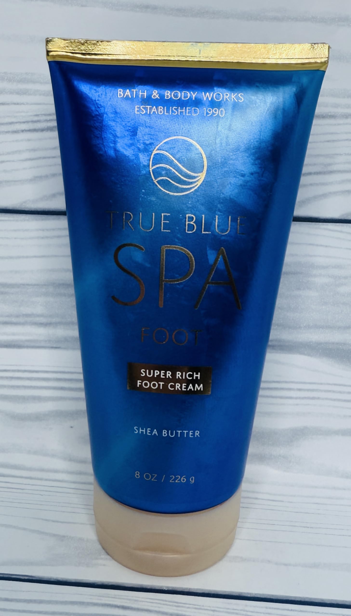 Packaging variation image featuring Bath & Body Works True Blue Spa Foot Cream on display.