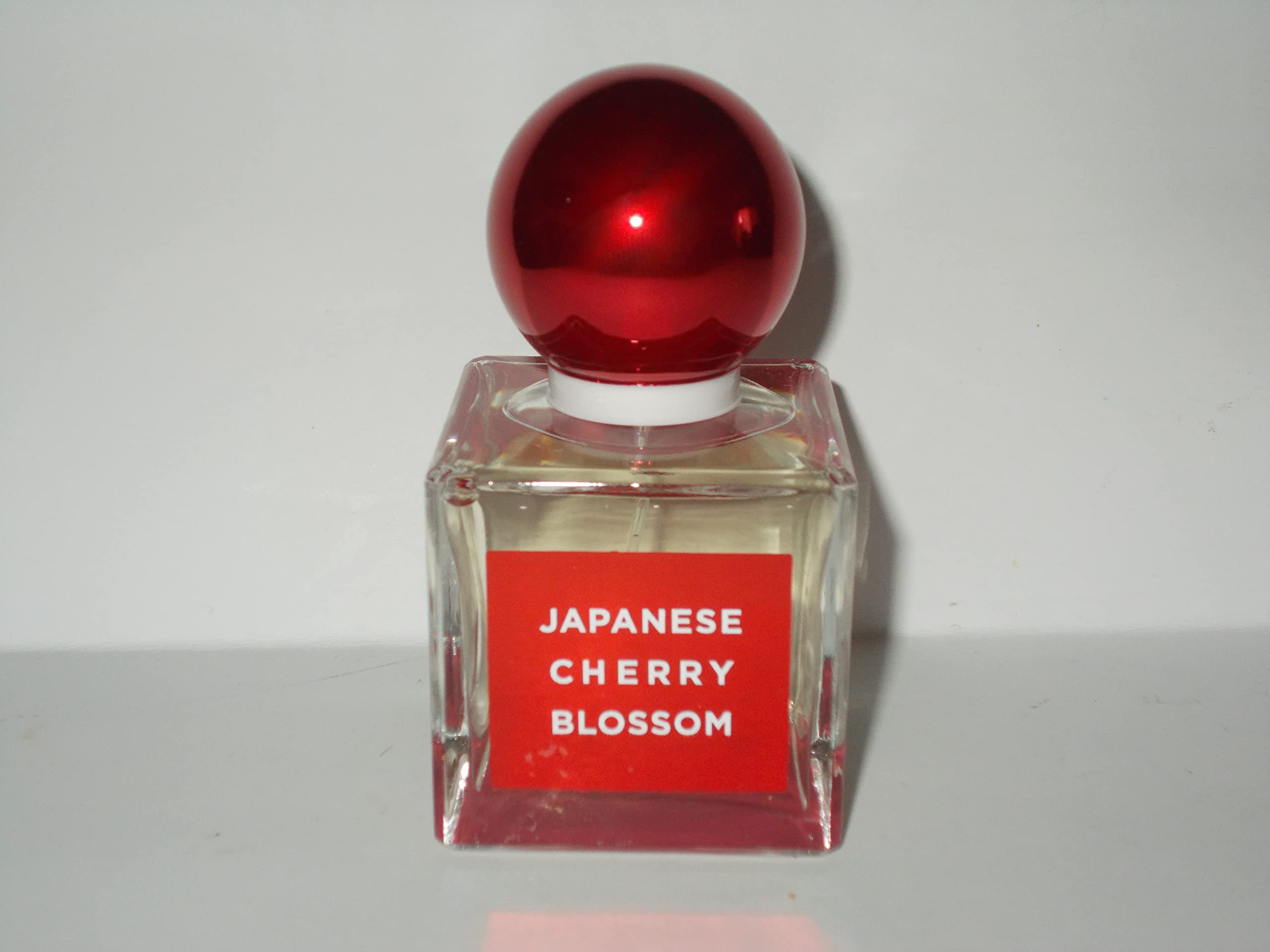 Close-up of Bath & Body Works Japanese Cherry Blossom EDP cap, premium packaging.