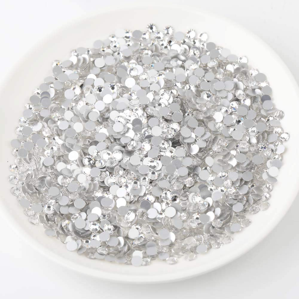 Beadsland nail art rhinestones shown with glue application for durable decoration.