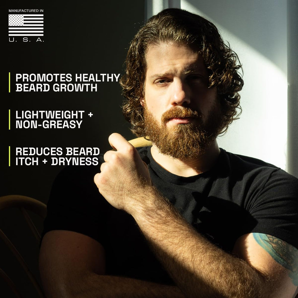Dropper applying oil for skin nourishment under beard.