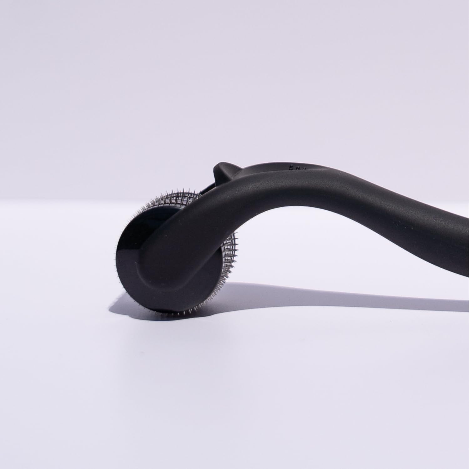 Beautimate microneedle derma roller on beard area for grooming.