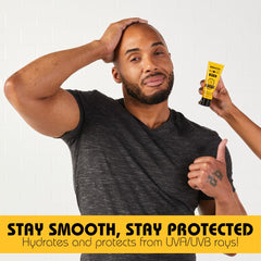 Hands applying moisturizer on shaved head for refreshed look.