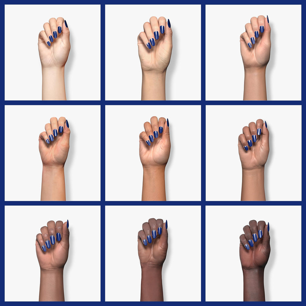 Beetles Blue Gel Polish on nail during base coat application for lasting color.
