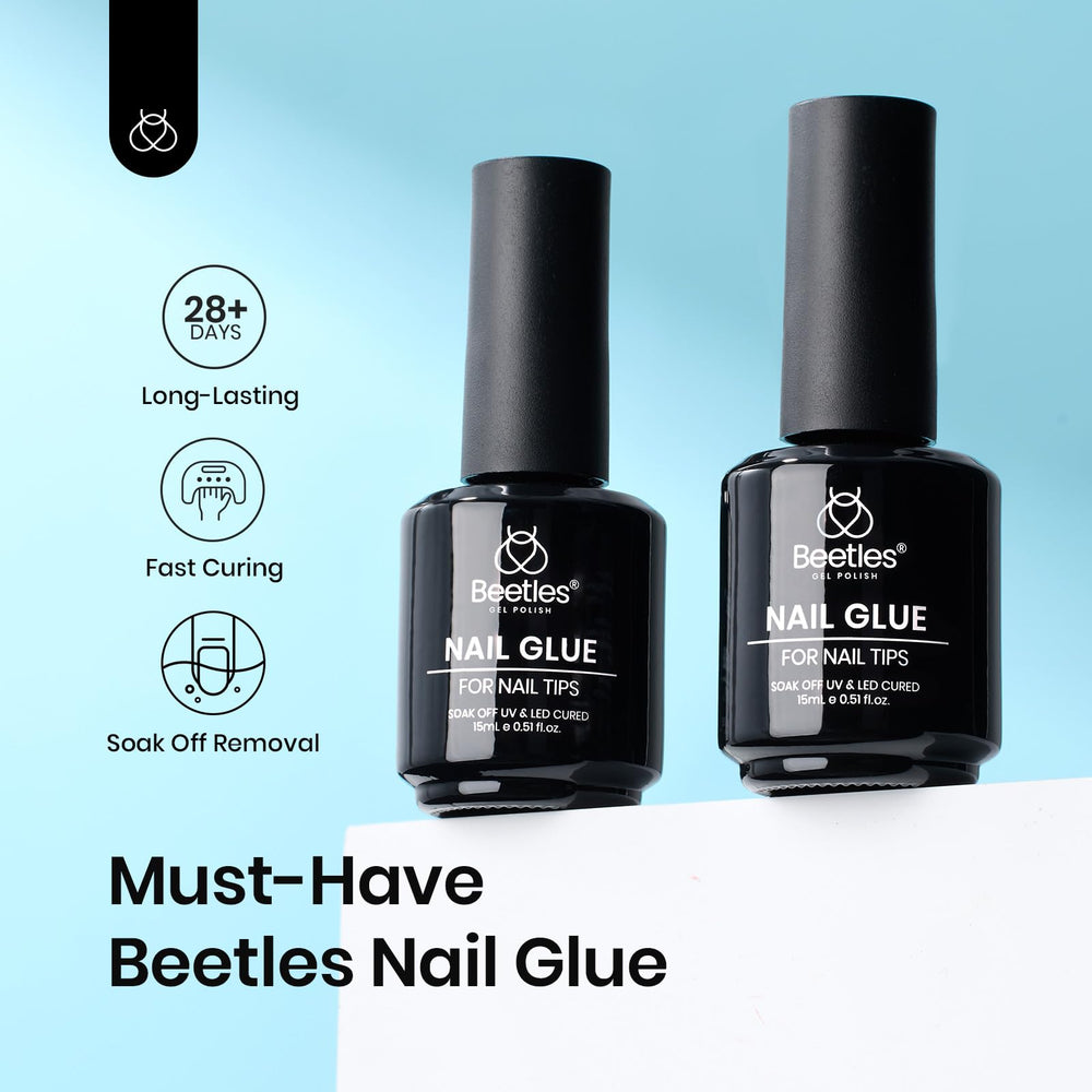 Beetles 9-in-1 gel brush applying nail glue for precise adhesion.
