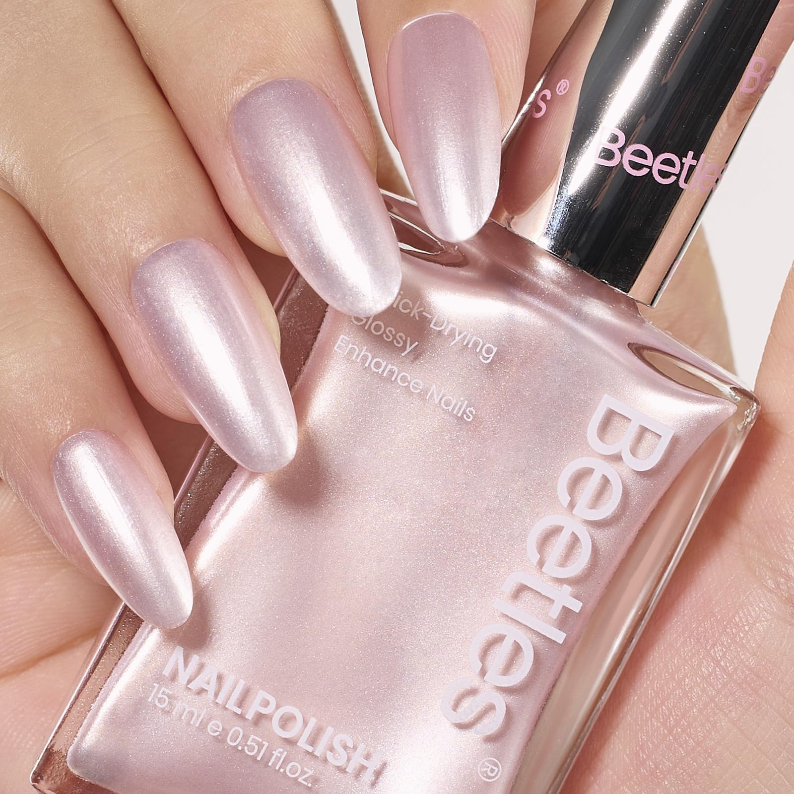Beetles Pink Pearl Nail Polish bottle close-up with rose nude shimmer.