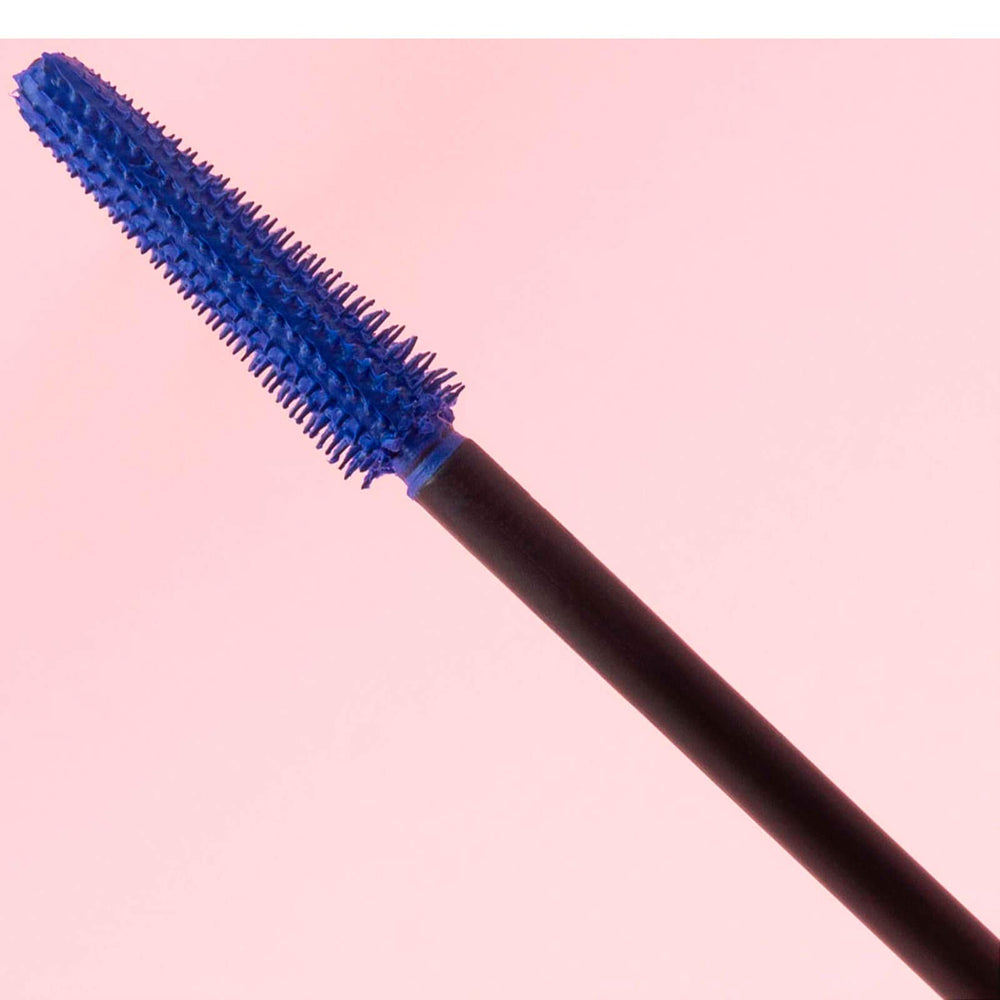 Bright blue mascara wand showing vibrant color on lashes.