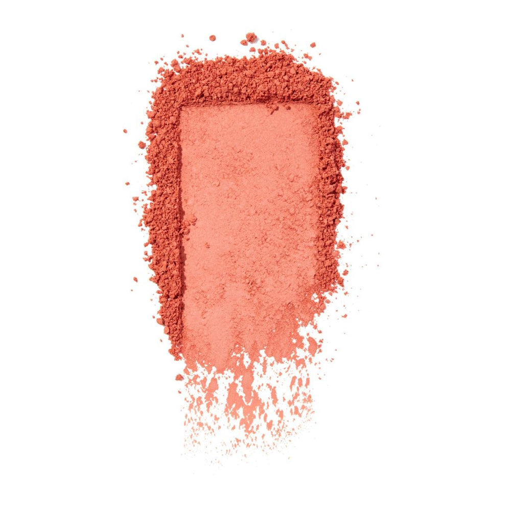 Benefit Sunny Warm Coral Blush swatch on cheek showing long-lasting matte finish.