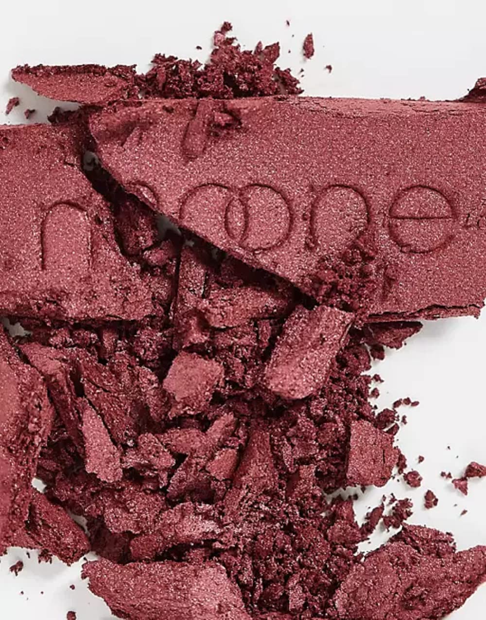 Travel-size blush held in palm for quick touch-ups.