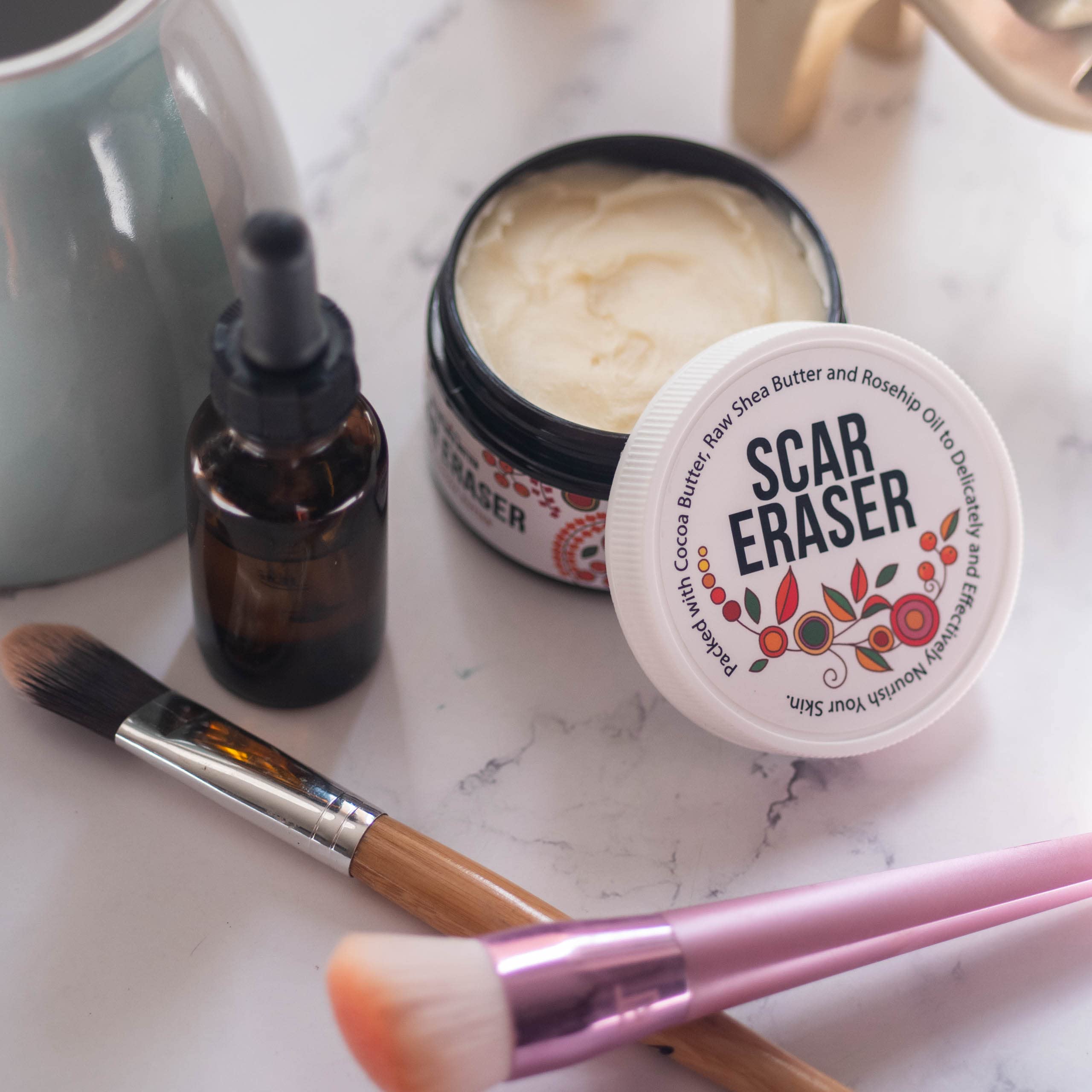 Better Shea Butter Scar Eraser Balm brush application on skin demonstration.