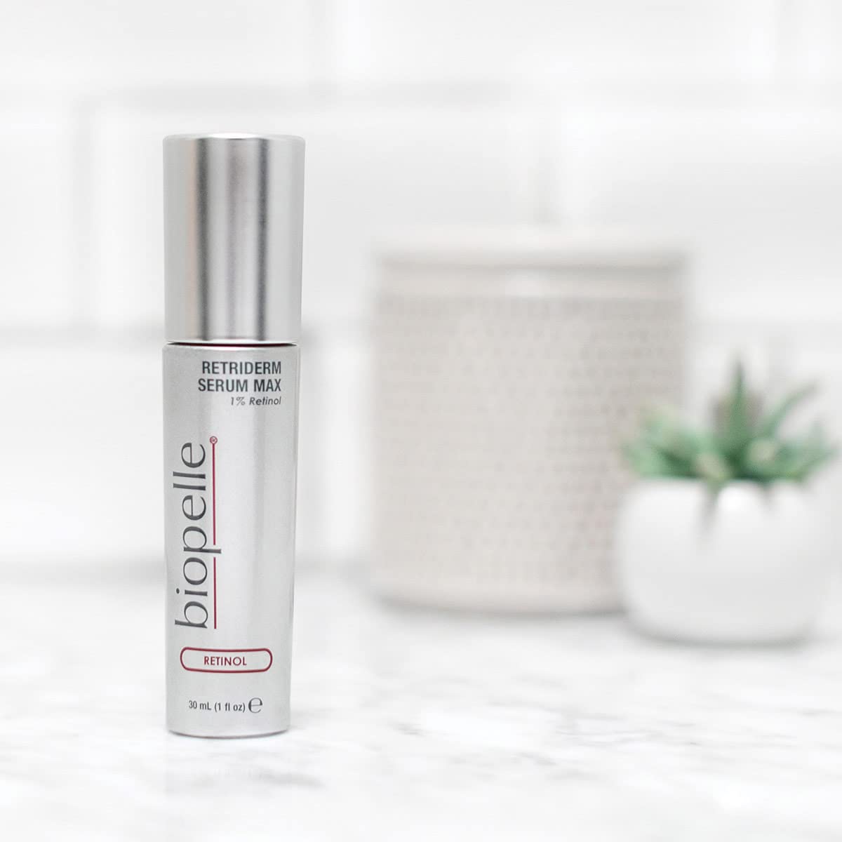Biopelle Retriderm serum drops on hand showing application texture.