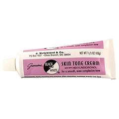 Black and White color correction cream swatch on skin showing natural finish.