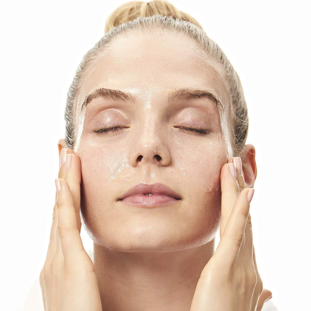 Product demonstrates water emulsification into a milky cleanser for gentle rinse.