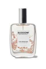 Blossom Sun-Drenched EDP bottle highlights bold amber-citrus scent for daily wear.