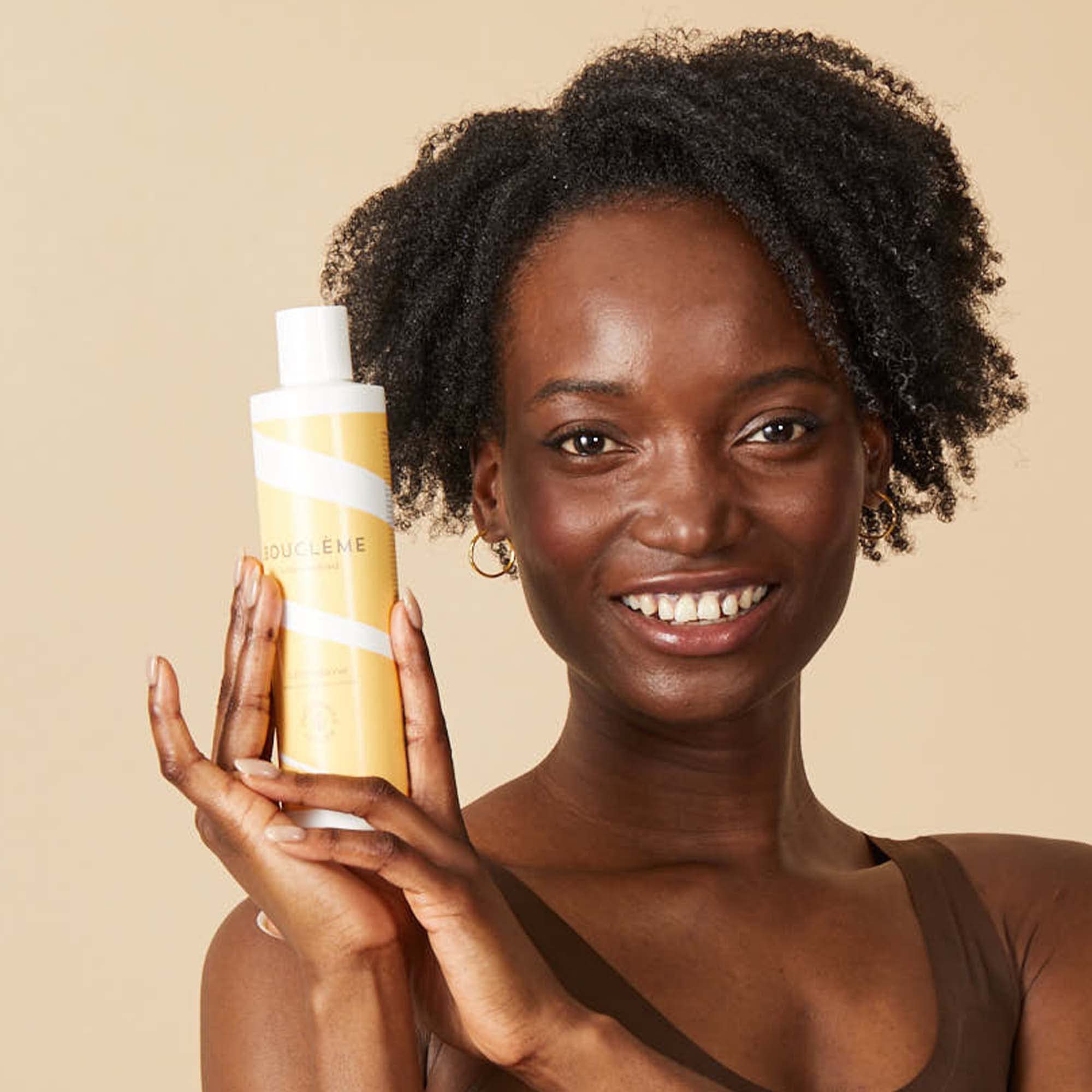 Boucleme Curl Conditioner bottle with tree planting symbol for sustainability