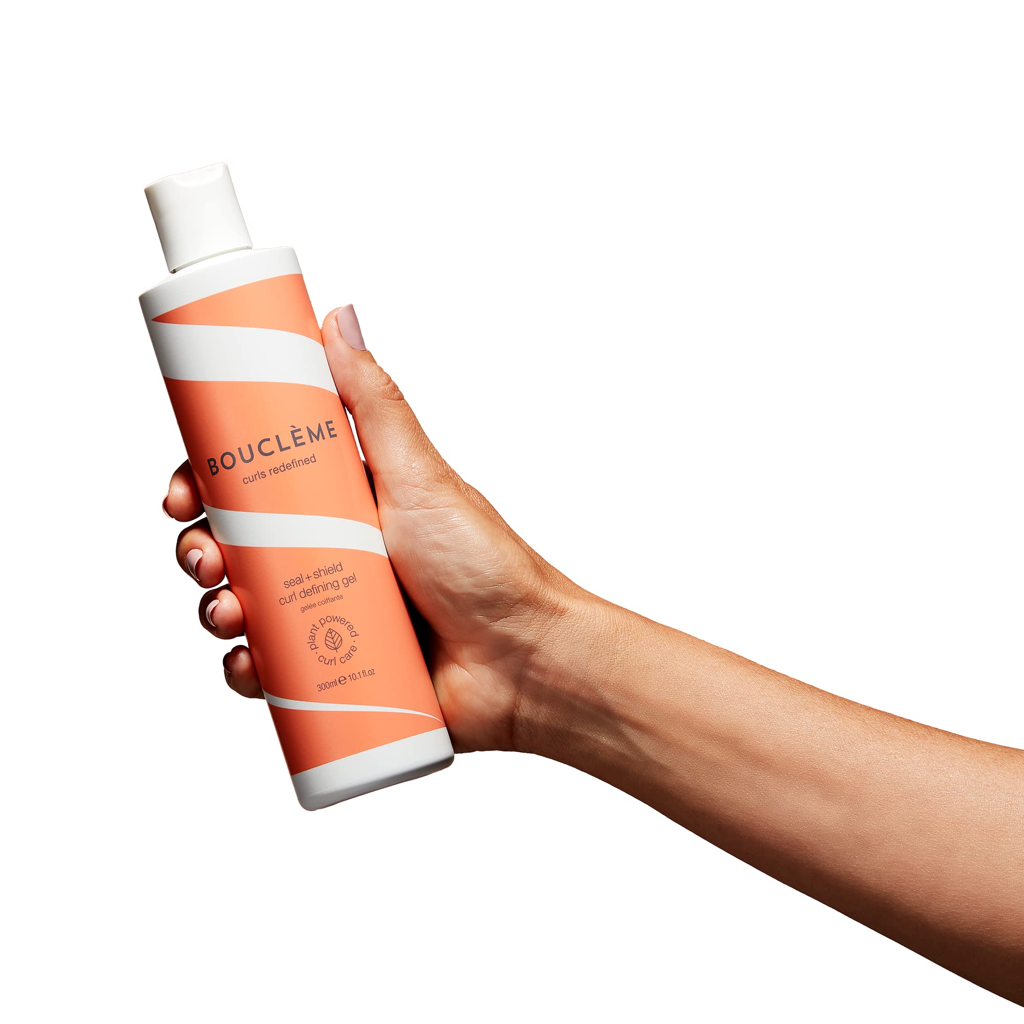 Boucléme Seal + Shield gel on defined curls for glossy, lasting style.