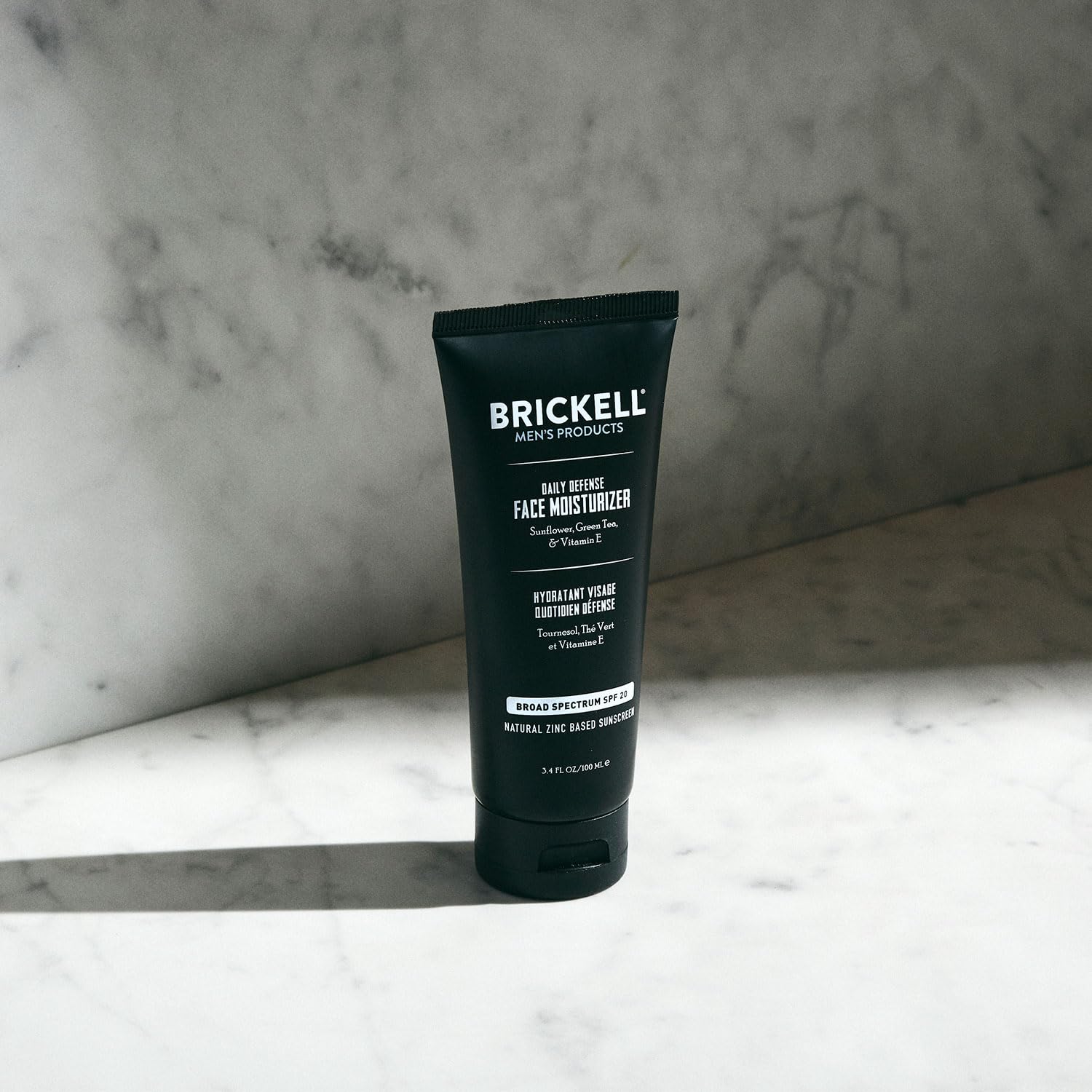 Packaging for Brickell Daily Defense SPF20 moisturizer emphasizing natural ingredients.
